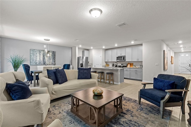 12277 Spring Hill Dr, Spring Hill, FL 34609 - living area featuring light wood-style floors, recessed lighting, and a textured ceiling