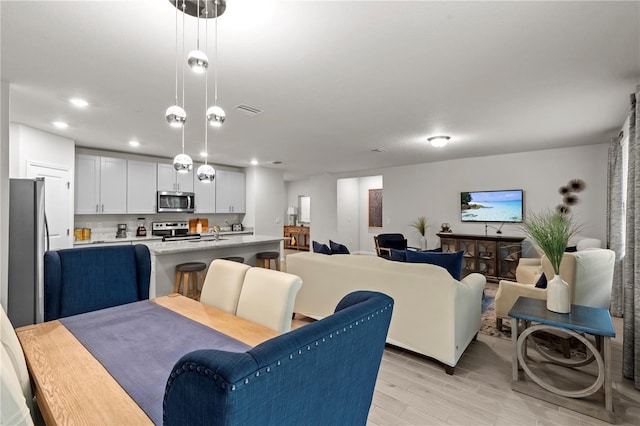 12277 Spring Hill Dr, Spring Hill, FL 34609 - dining room with light wood-style flooring and recessed lighting