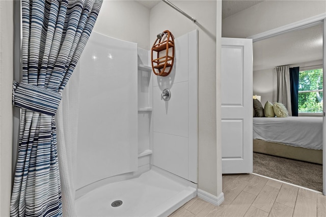 12277 Spring Hill Dr, Spring Hill, FL 34609 - bathroom featuring ensuite bath, walk in shower, and wood finished floors