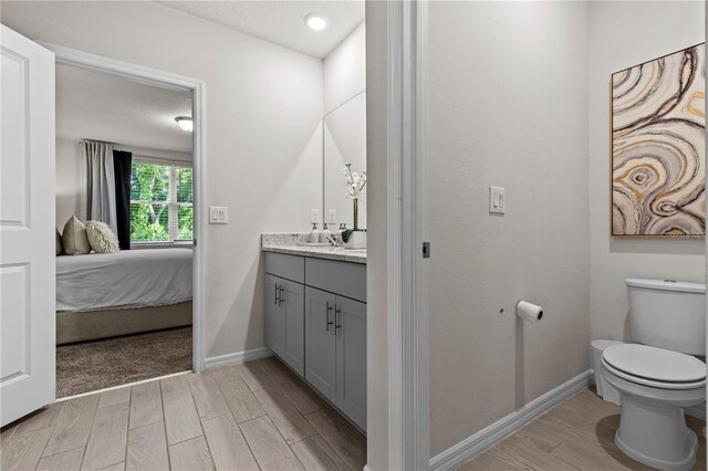 12277 Spring Hill Dr, Spring Hill, FL 34609 - bathroom with vanity, wood finished floors, and ensuite bathroom