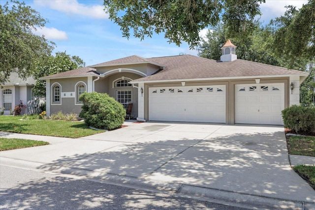 27826 Sora Blvd, Wesley Chapel, FL 33544 - view of front of house with a garage, stucco siding, driveway, a front yard, and a shingled roof