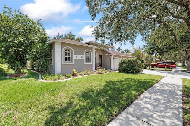 27826 Sora Blvd, Wesley Chapel, FL 33544 - mediterranean / spanish home featuring an attached garage, stucco siding, driveway, and a front yard