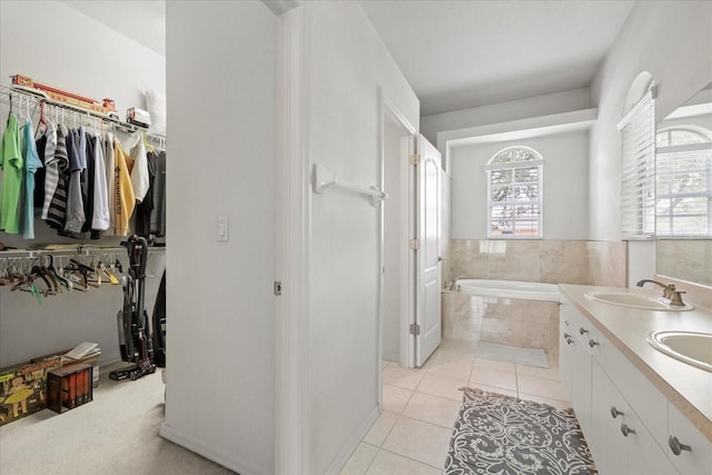 27826 Sora Blvd, Wesley Chapel, FL 33544 - bathroom with a bath, a walk in closet, tile patterned flooring, and double vanity