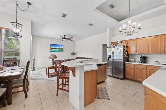 27826 Sora Blvd, Wesley Chapel, FL 33544 - kitchen with appliances with stainless steel finishes, a chandelier, light tile patterned flooring, and light countertops