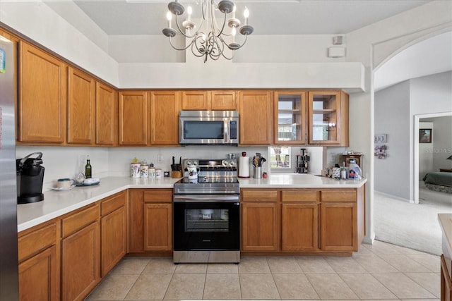 27826 Sora Blvd, Wesley Chapel, FL 33544 - kitchen featuring appliances with stainless steel finishes, brown cabinetry, and light countertops