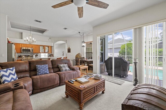 27826 Sora Blvd, Wesley Chapel, FL 33544 - living area with a ceiling fan, a chandelier, light carpet, and arched walkways