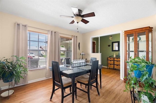 7022 Kingsway Dr, Port Richey, FL 34668 - dining space featuring light wood-style flooring, ceiling fan, and a textured ceiling