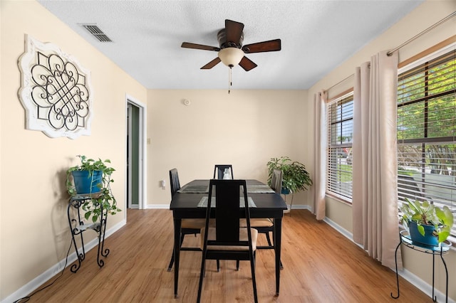 7022 Kingsway Dr, Port Richey, FL 34668 - dining space featuring ceiling fan, light wood-style flooring, and a textured ceiling