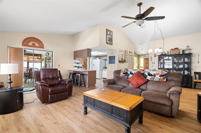 7022 Kingsway Dr, Port Richey, FL 34668 - living room featuring light wood-type flooring, a ceiling fan, vaulted ceiling, and a chandelier