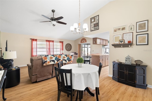 7022 Kingsway Dr, Port Richey, FL 34668 - dining room featuring vaulted ceiling, light wood-style flooring, a ceiling fan, and a chandelier