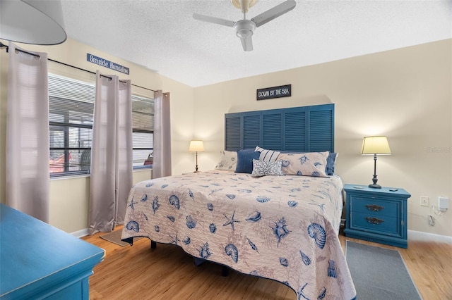 7022 Kingsway Dr, Port Richey, FL 34668 - bedroom featuring wood finished floors, ceiling fan, and a textured ceiling