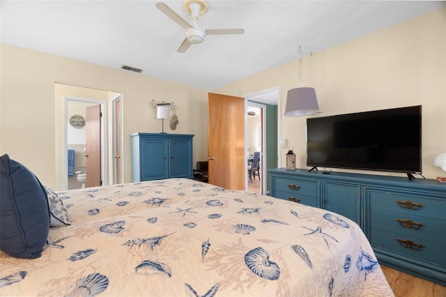 7022 Kingsway Dr, Port Richey, FL 34668 - bedroom featuring lofted ceiling, ceiling fan, wood finished floors, and ensuite bathroom