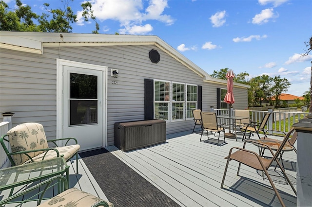 2221 W Lake Dr, Wimauma, FL 33598 - wooden deck with outdoor dining area