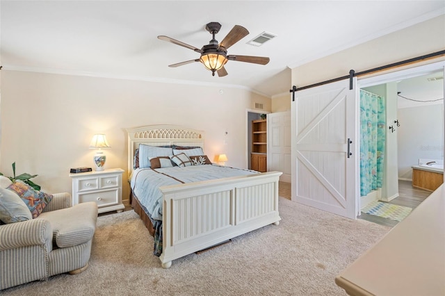 2221 W Lake Dr, Wimauma, FL 33598 - carpeted bedroom featuring ornamental molding, a barn door, and a ceiling fan