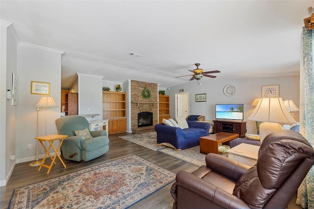 2221 W Lake Dr, Wimauma, FL 33598 - living area with a ceiling fan, a stone fireplace, dark wood-style floors, and ornamental molding