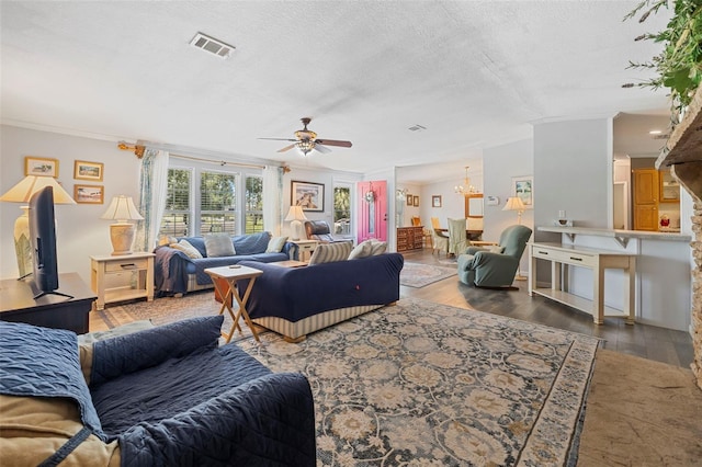 2221 W Lake Dr, Wimauma, FL 33598 - living room with wood finished floors, ceiling fan, a textured ceiling, a chandelier, and crown molding