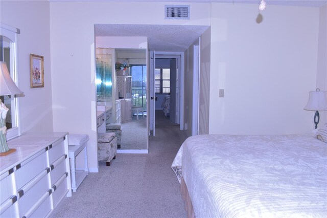 3200 Cove Cay Dr Unit 5F, Clearwater, FL 33760 - bedroom featuring light colored carpet and connected bathroom