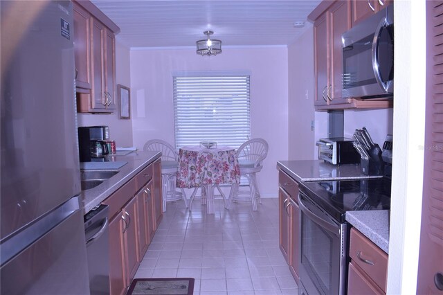 3200 Cove Cay Dr Unit 5F, Clearwater, FL 33760 - kitchen featuring stainless steel appliances and light tile patterned floors