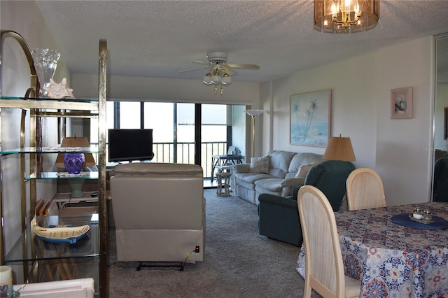 3200 Cove Cay Dr Unit 5F, Clearwater, FL 33760 - carpeted living area with a chandelier, a ceiling fan, and a textured ceiling