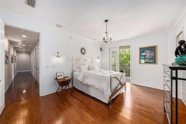1731 W Watrous Ave Unit 202, Tampa, FL 33606 - bedroom featuring access to outside, hardwood / wood-style flooring, a chandelier, ornamental molding, and a textured ceiling
