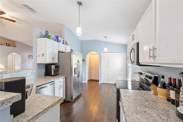 7804 Country Chase Ave, Lakeland, FL 33810 - kitchen featuring appliances with stainless steel finishes, arched walkways, lofted ceiling, dark wood-style floors, and white cabinets