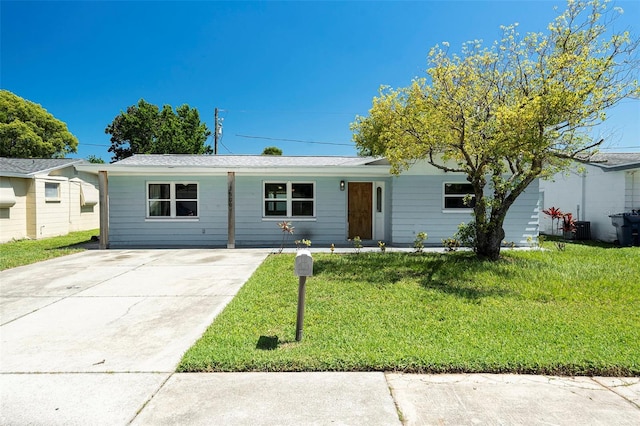 3509 Brookston Dr, Holiday, FL 34691 - ranch-style home with a front lawn and concrete driveway