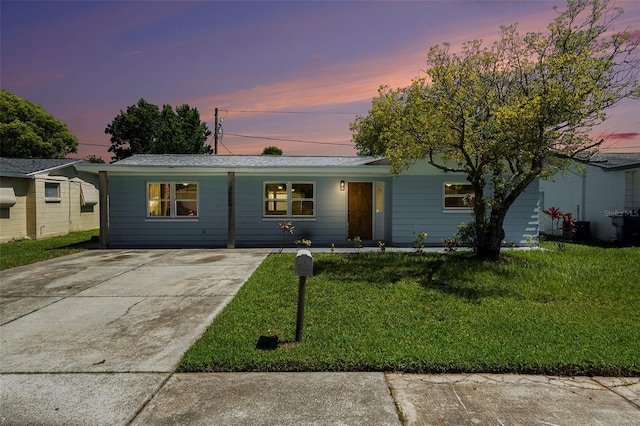 3509 Brookston Dr, Holiday, FL 34691 - ranch-style home with a lawn and concrete driveway