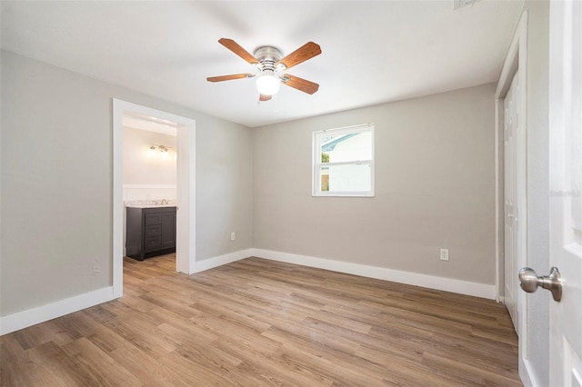 3509 Brookston Dr, Holiday, FL 34691 - unfurnished bedroom featuring light wood-style flooring, ensuite bathroom, and ceiling fan