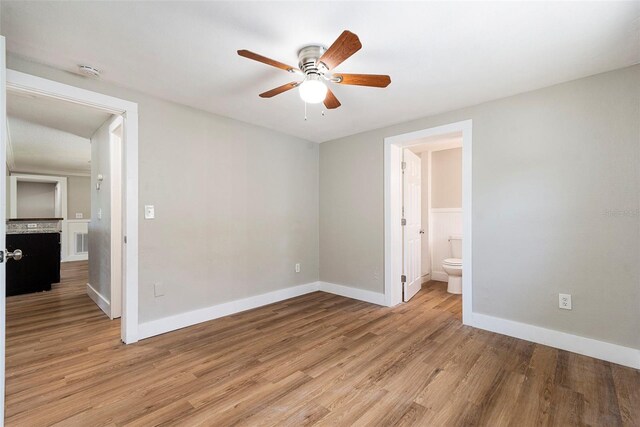 3509 Brookston Dr, Holiday, FL 34691 - unfurnished bedroom featuring light wood-style floors, connected bathroom, and ceiling fan