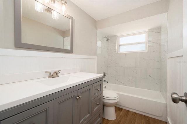 3509 Brookston Dr, Holiday, FL 34691 - full bathroom featuring vanity, wainscoting, washtub / shower combination, and wood finished floors