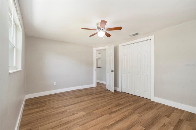 3509 Brookston Dr, Holiday, FL 34691 - unfurnished bedroom featuring light wood-style floors, a closet, and ceiling fan
