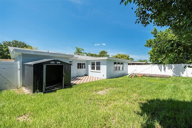 3509 Brookston Dr, Holiday, FL 34691 - back of property with a fenced backyard, a storage shed, and a patio
