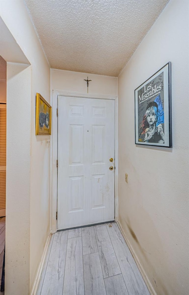 5265 E Bay Dr Unit 521, Clearwater, FL 33764 - entryway featuring light wood-type flooring and a textured ceiling