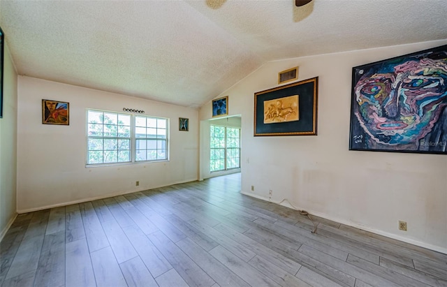5265 E Bay Dr Unit 521, Clearwater, FL 33764 - unfurnished room with a textured ceiling, wood finished floors, lofted ceiling, and ceiling fan