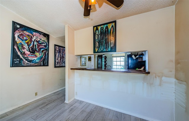 5265 E Bay Dr Unit 521, Clearwater, FL 33764 - empty room with a textured ceiling, wood finished floors, and a ceiling fan