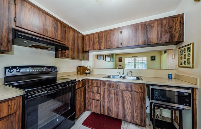 5265 E Bay Dr Unit 521, Clearwater, FL 33764 - kitchen featuring black range with electric cooktop, range hood, and light countertops