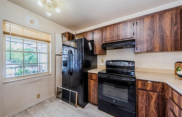5265 E Bay Dr Unit 521, Clearwater, FL 33764 - kitchen with black appliances, under cabinet range hood, light countertops, and light marble finish floors