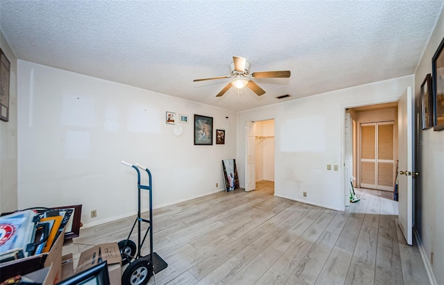 5265 E Bay Dr Unit 521, Clearwater, FL 33764 - unfurnished office featuring light wood-type flooring, ceiling fan, and a textured ceiling