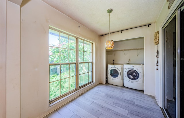5265 E Bay Dr Unit 521, Clearwater, FL 33764 - laundry area with independent washer and dryer, a textured ceiling, and light wood finished floors