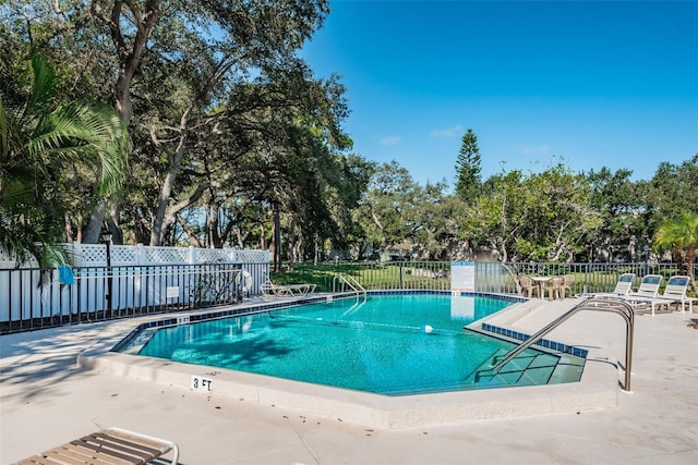 5265 E Bay Dr Unit 521, Clearwater, FL 33764 - community pool featuring a patio area and view of wooded area