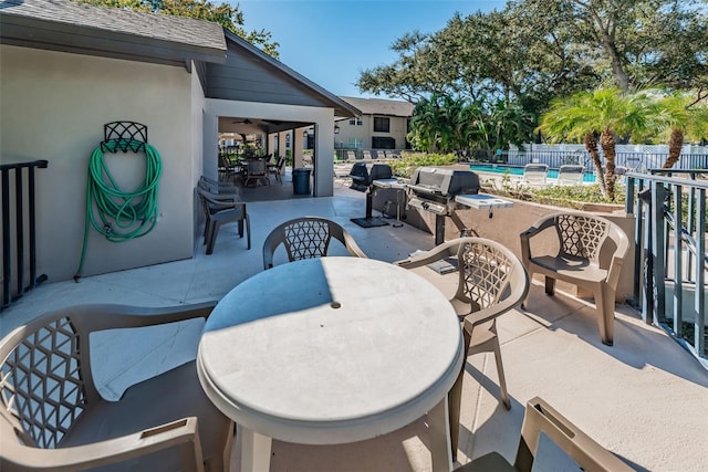 5265 E Bay Dr Unit 521, Clearwater, FL 33764 - view of patio featuring ceiling fan and outdoor dining space