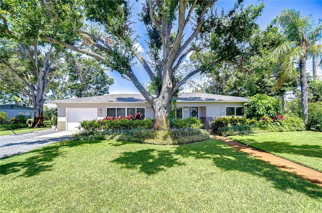 2201 Horan Way S, Gulfport, FL 33707 - ranch-style house featuring driveway, a garage, a front yard, and stucco siding