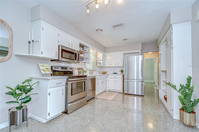 2201 Horan Way S, Gulfport, FL 33707 - kitchen with appliances with stainless steel finishes, light countertops, open shelves, and white cabinets