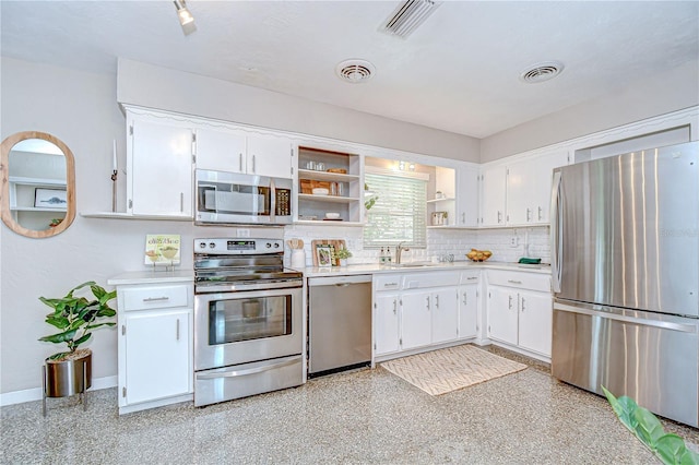 2201 Horan Way S, Gulfport, FL 33707 - kitchen with stainless steel appliances, open shelves, light countertops, and white cabinets