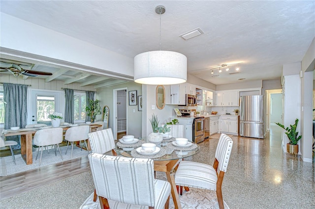 2201 Horan Way S, Gulfport, FL 33707 - dining space featuring ceiling fan, beamed ceiling, and a textured ceiling