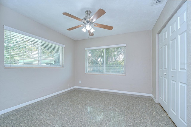 2201 Horan Way S, Gulfport, FL 33707 - unfurnished bedroom with multiple windows, a closet, and speckle patterned floor