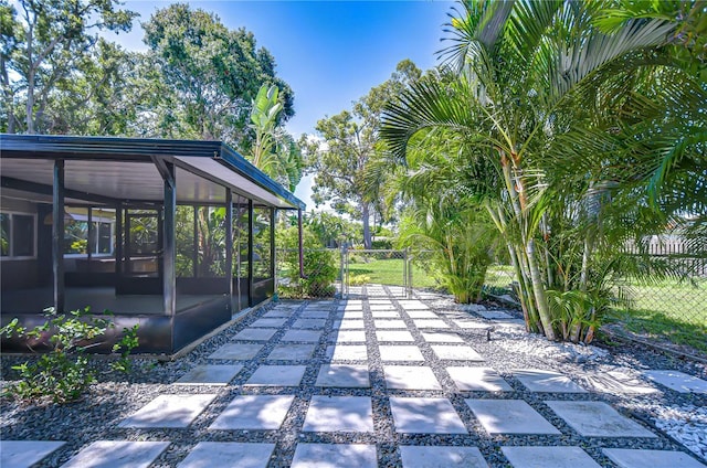 2201 Horan Way S, Gulfport, FL 33707 - view of patio featuring a sunroom and a gate