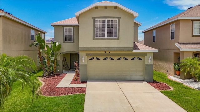 12121 Tree Haven Ave, Gibsonton, FL 33534 - view of front of property with a shingled roof, stucco siding, driveway, and a garage
