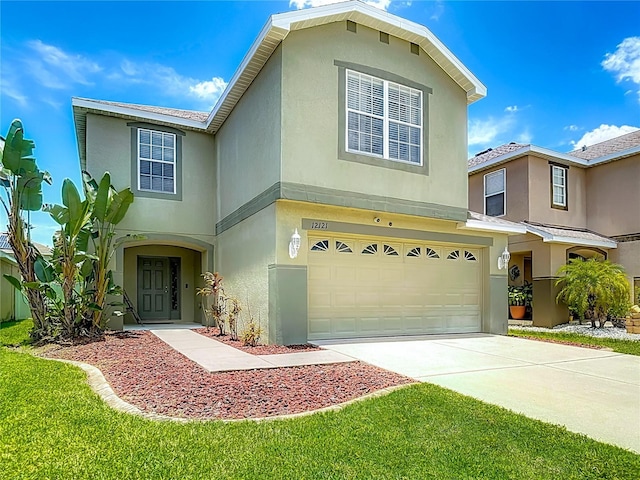 12121 Tree Haven Ave, Gibsonton, FL 33534 - view of front facade with an attached garage, stucco siding, and concrete driveway