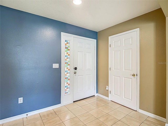 12121 Tree Haven Ave, Gibsonton, FL 33534 - foyer with light tile patterned floors and baseboards